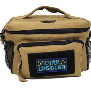 May include: A tan canvas lunch bag with a black zipper and a black mesh pocket on the side. The bag has a black patch with the text "DIRK DIGGLER" in blue and yellow.