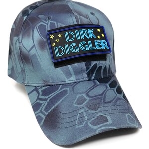 May include: A blue camouflage baseball cap with a black patch that says "DIRK DIGGLER" in blue neon letters with yellow stars.
