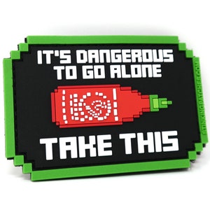 May include: Green and black pixelated patch with the text "It's dangerous to go alone. Take this." and a pixelated image of a red hot sauce bottle.