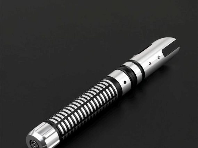 Pu&ograve; includere: Un'elica di spada laser argento e nera con un design dettagliato. L'impugnatura presenta un motivo a coste e accenti neri, mentre l'emettitore ha un design a fessura distintivo. L'estetica generale &egrave; elegante e futuristica.