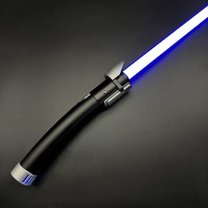 May include: A black lightsaber with a bright blue blade. The hilt has silver accents and a silver end cap. The lightsaber is angled diagonally across a dark background.