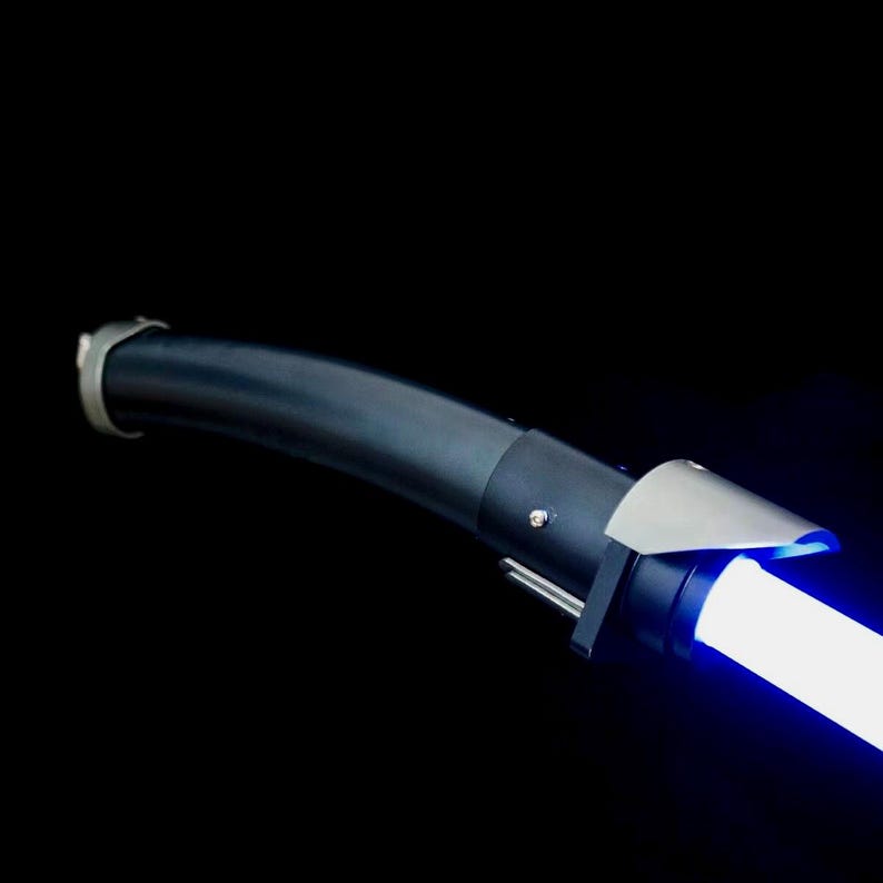 May include: A black lightsaber with a silver hilt and a bright blue blade. The hilt has a curved design with a metallic accent near the blade. The background is solid black.