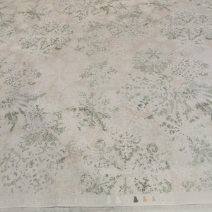 May include: Off-white cotton fabric with a snowflake pattern in shades of green and beige. The fabric has a subtle, textured appearance. The text "100% cotton Pattern # 30227" is printed along the edge, along with bell icons.