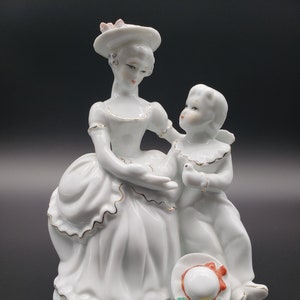 Vintage 1950 porcelain figurine of a woman & child with gold accents