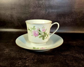 Vintage porcelain footed tea cup and saucer, pink rose design with gold trim