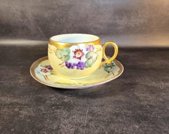Antique Limoges-style porcelain teacup and saucer