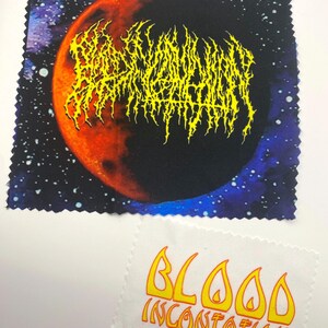 May include: Two small, rectangular fabric patches. One features a yellow, stylized text design over a red and black moon against a starry background. The other patch has the words "BLOOD INCANTATION" in yellow flames.