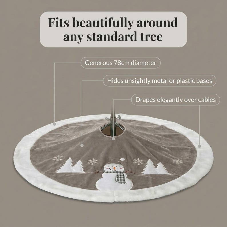 May include: A circular taupe Christmas tree skirt with a white faux fur border, featuring an embroidered snowman wearing a plaid scarf, white pine trees, and snowflakes. The text reads: Fits beautifully around any standard tree, Generous 78cm diameter, Hides unsightly metal or plastic bases, Drapes elegantly over cables.