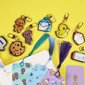 Cosmokii cute keyrings, bookmarks, washi tape photographed on a fun yellow background