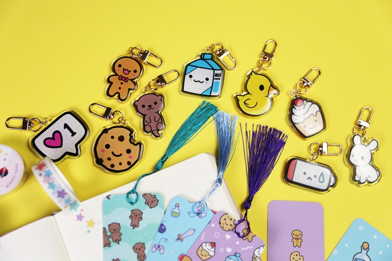 Cosmokii cute keyrings, bookmarks, washi tape photographed on a fun yellow background