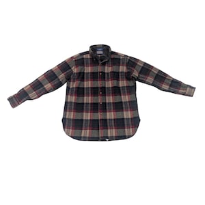 May include: A button-down flannel shirt in a plaid pattern of black, red, tan, and gray. The long-sleeved shirt is spread out on a white background, showing the collar and buttoned front.