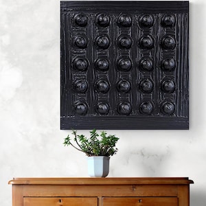 May include: Black and white abstract wall art with a textured surface. The art features a grid of raised circles.