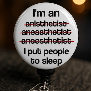Close-up macro detail of CRNA badge reel glossy mylar dome surface showing red strike-through text and durable print quality