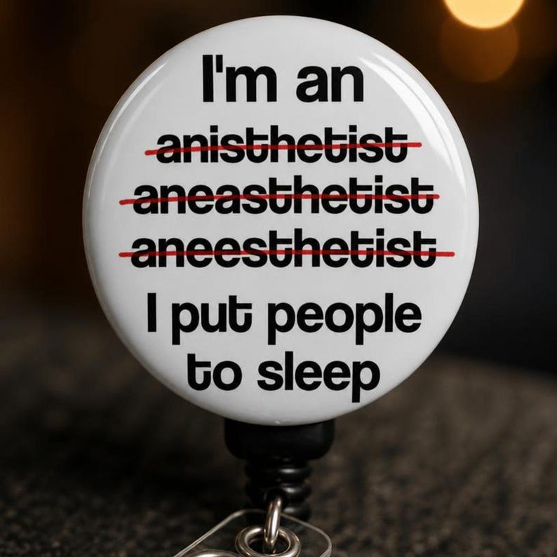 Close-up macro detail of CRNA badge reel glossy mylar dome surface showing red strike-through text and durable print quality