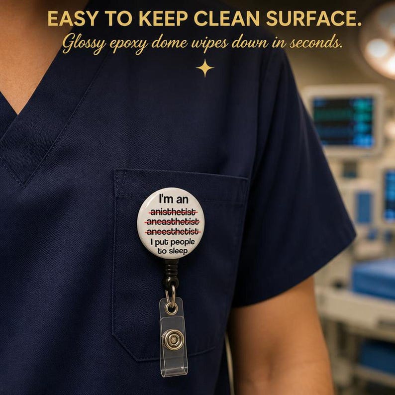 CRNA badge reel clipped to navy blue scrubs - EASY TO KEEP CLEAN SURFACE glossy mylar dome wipes down in seconds