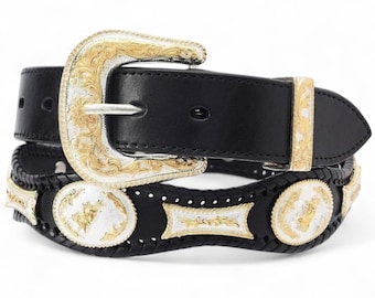 May include: Black leather belt with a silver and gold buckle and accents. The buckle is ornate with a floral design. The belt has a decorative braided section with silver and gold embellishments. A classic western style.