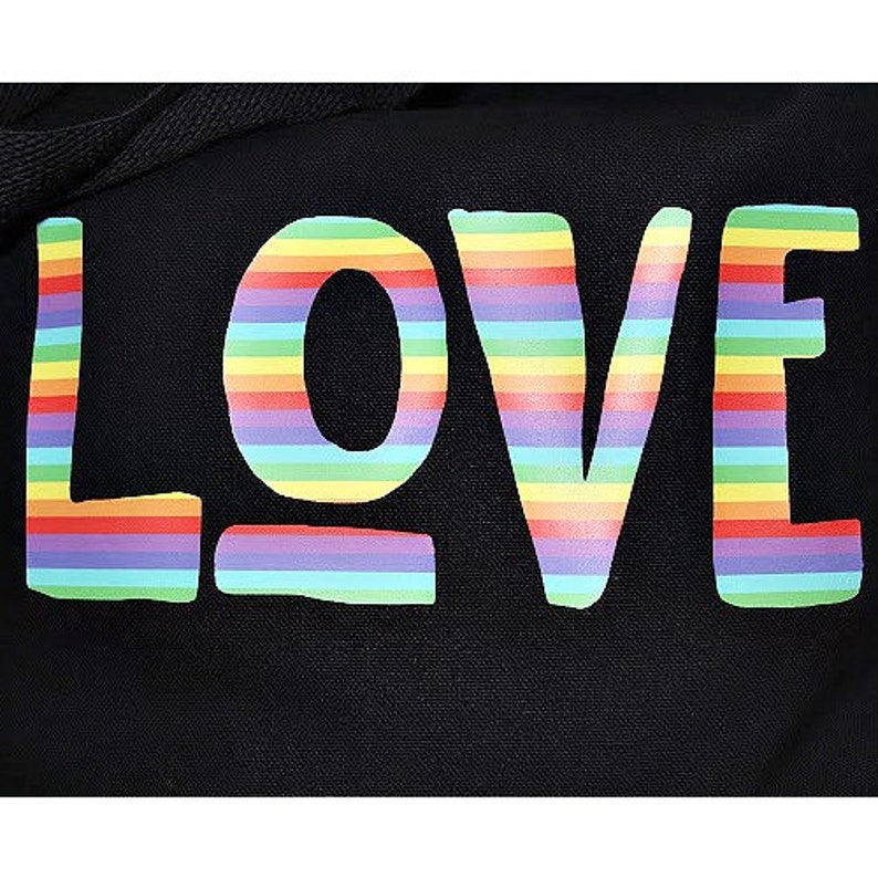 May include: Black canvas tote bag with the word "LOVE" printed in rainbow colors.