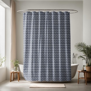May include: A blue and white shower curtain with a chevron pattern. The curtain is hanging on a curved shower rod.