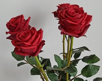 Roses. Red polymer clay roses for home decor. Red bouquet of roses for interior and as a gift. Realistic rose. Branches of roses.