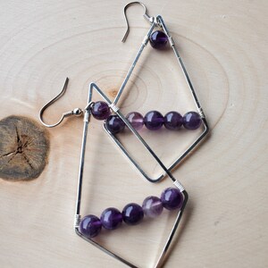 Silver geometric hoop earrings with wire wrapped Amethyst beads