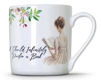 May include: White ceramic mug featuring a floral design and a woman reading a book. The mug has the text "I Should Infinitely Prefer a Book" printed on it.
