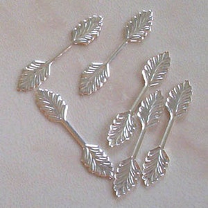 May include: Silver leaf embellishments with a textured design. These decorative pieces are perfect for adding a touch of elegance to crafts and jewellery.