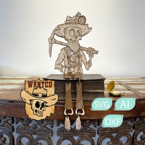 May include: A laser-cut wooden figure of a bearded skeleton miner wearing a hat with a lamp, holding a pickaxe and a stone. Beside it is a wooden sign with a skull wearing a cowboy hat and the text WANTED. Includes SVG, AI, and DXF labels.