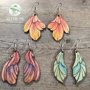 May include: A set of six wooden earrings with floral designs. The earrings are painted in shades of pink, orange, and blue. The earrings are all different shapes and sizes.