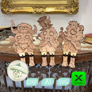 May include: Three wooden Halloween-themed figures with stitched details. The figures are standing on a wooden surface with a decorative metal railing. The figures are wearing hats and have a stitched mouth and eyes. The figures are holding small objects in their hands.