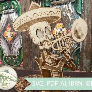 May include: A wooden cutout of a skeleton mariachi playing a trumpet, wearing a sombrero. The skeleton is light brown with etched details. The image includes a small circular logo with a skull wearing a sombrero. Text at the bottom reads "SVG, PDF, AI, IBRN, IBRN2".