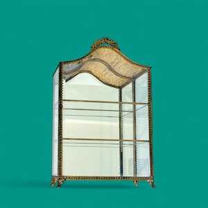Glass Vitrine Cabinet with intricate gold accents and a timeless design piece