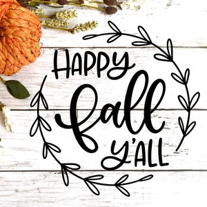 May include: A white wooden background with a black calligraphy design that says "Happy Fall Y'all" with a wreath of leaves around the text.
