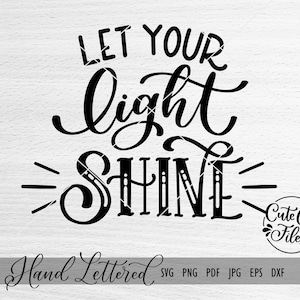 May include: Black and white hand-lettered calligraphy design with the text "Let your light shine".