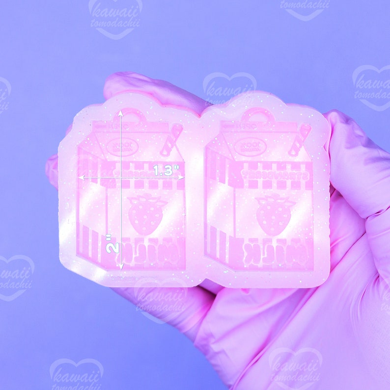 May include: A pink resin mold in the shape of a strawberry milk carton. The mold is 2 inches tall and 1.3 inches wide. The carton design includes a strawberry graphic and the text "YooHoo Strawberry Milk".