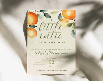 May include: A rectangular baby shower invitation card featuring watercolour oranges and green leaves. The text reads: A little cutie is on the way! Join us for a baby shower honouring Felicity Merriman, Sunday, November 02, 2025, at 2 PM.