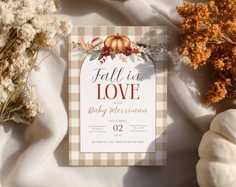 May include: A rectangular invitation card with a beige and white gingham pattern border. The center features an arched design with a pumpkin and floral illustration, text reading Fall in LOVE with Baby Merriman, November 02, 2030, and address details.