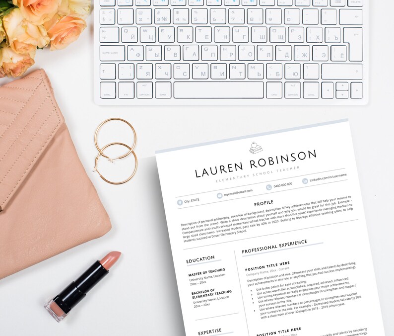 May include: A resume template for an elementary school teacher named Lauren Robinson, featuring a white keyboard, a pink quilted clutch, gold hoop earrings, a tube of pink lipstick, and a bouquet of peach roses on a white surface.