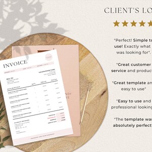 Invoice template laying on top of magazine and round chopping board, next to gold pen and 5 star client reviews.