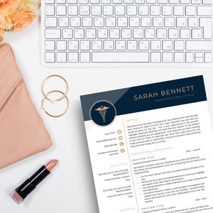 Resume template laying next to nude purse, gold earrings and lipstick.