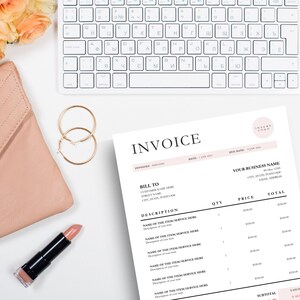 Invoice template laying next to nude purse, gold earrings and lipstick.