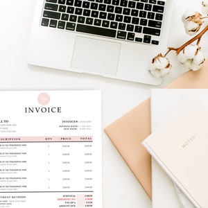 Soft pink and white Invoice Template on top of a white desk, computer and notebook.