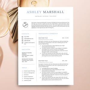 May include: A white resume template for a primary school teacher named Ashley Marshall. The document features sections for contact information, education, skills, and professional experience with placeholder text and a small apple icon.