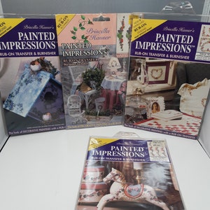 May include: Four packages of Priscilla Hauser's Painted Impressions rub-on transfer and burnisher kits. The kits feature various designs, including a birdhouse, a rocking horse, and a floral wreath. The packages are all white with blue and red accents.
