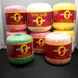 May include: Six spools of South Maid Super Saver 100% Mercerized Cotton yarn in various colors: pink, white, yellow, green, peach, and orange. Each spool has 600 yards of yarn.