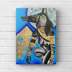 May include: A painting of an Egyptian goddess with a jackal head. She is wearing gold jewelry and has a blue background with gold accents. The painting is signed "KatshawArt 2022".