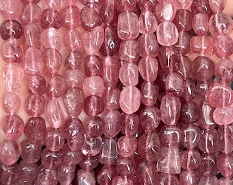 May include: A strand of pink, faceted, tumbled rose quartz beads. The beads are irregular in shape and have a translucent appearance.