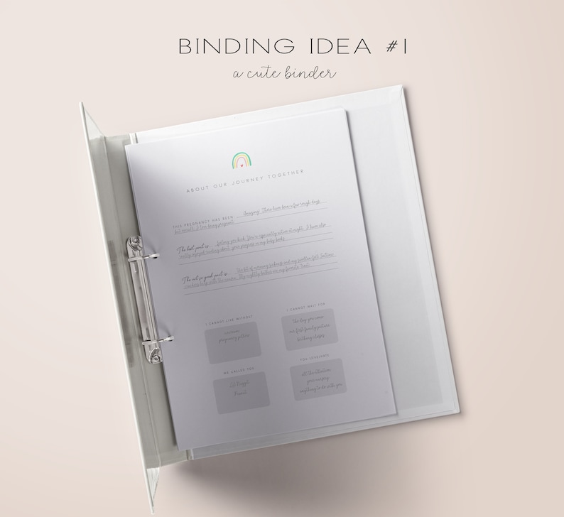 Op de afbeelding: Een witte binder met een regenboogontwerp en de tekst "BINDING IDEA #1 a cute binder" op de omslag. De binder is open op een pagina met de titel "ABOUT OUR JOURNEY TOGETHER" en verschillende secties om in te schrijven.