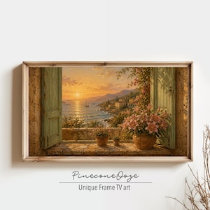 May include: A rectangular framed wall art piece titled PineconeOoze Unique Frame TV art, depicting an open window view of a coastal sunset over a sea with a sailboat, stone buildings, and a terracotta pot filled with pink lilies on the sill.