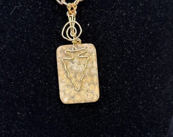 Hand shaped arrowhead charm dangles on coral fossil agate necklace