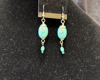 Turquoise like bead capped by silver wire hand shaped spirals earrings